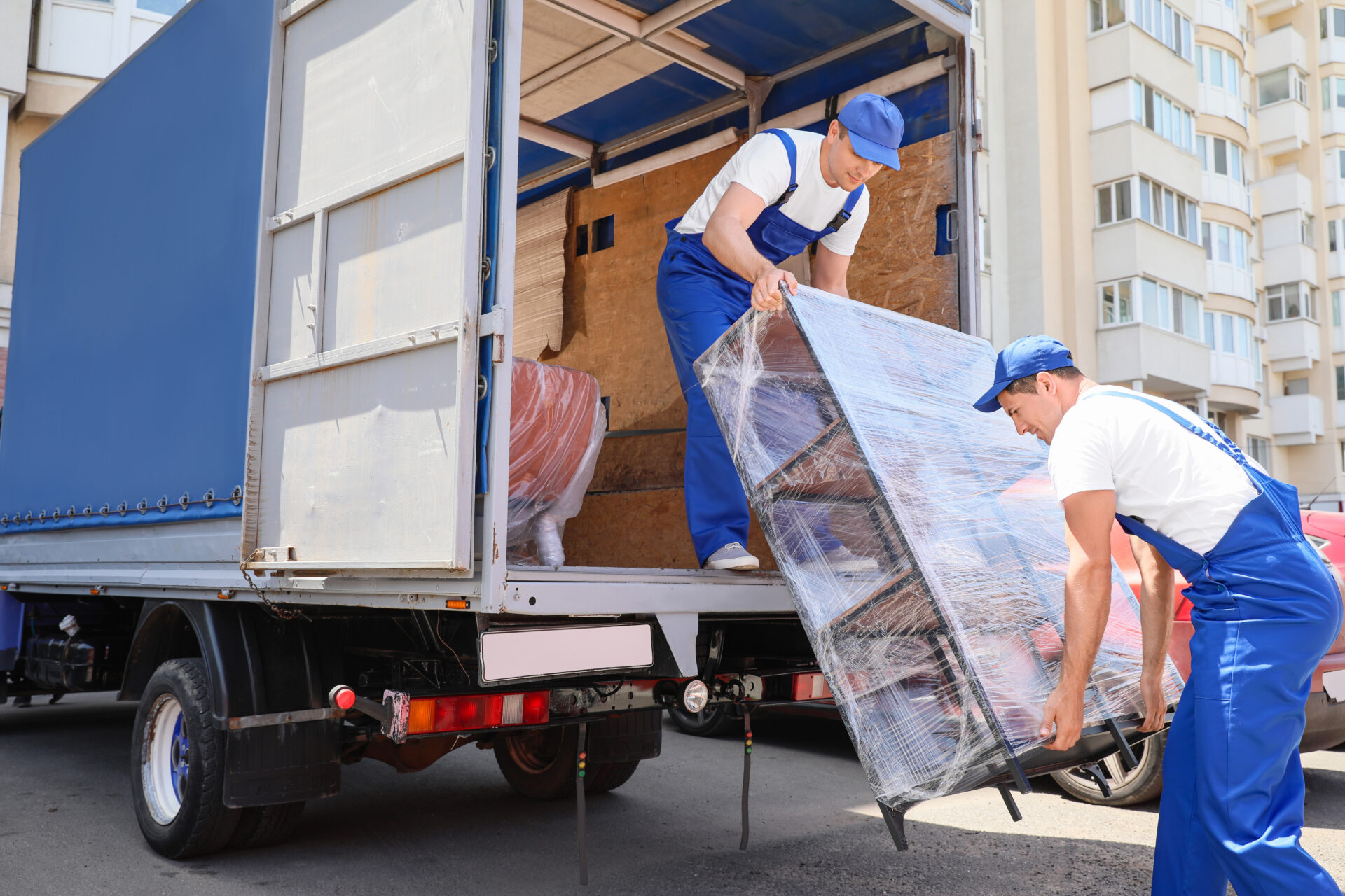 Professional movers loading furniture into a moving truck